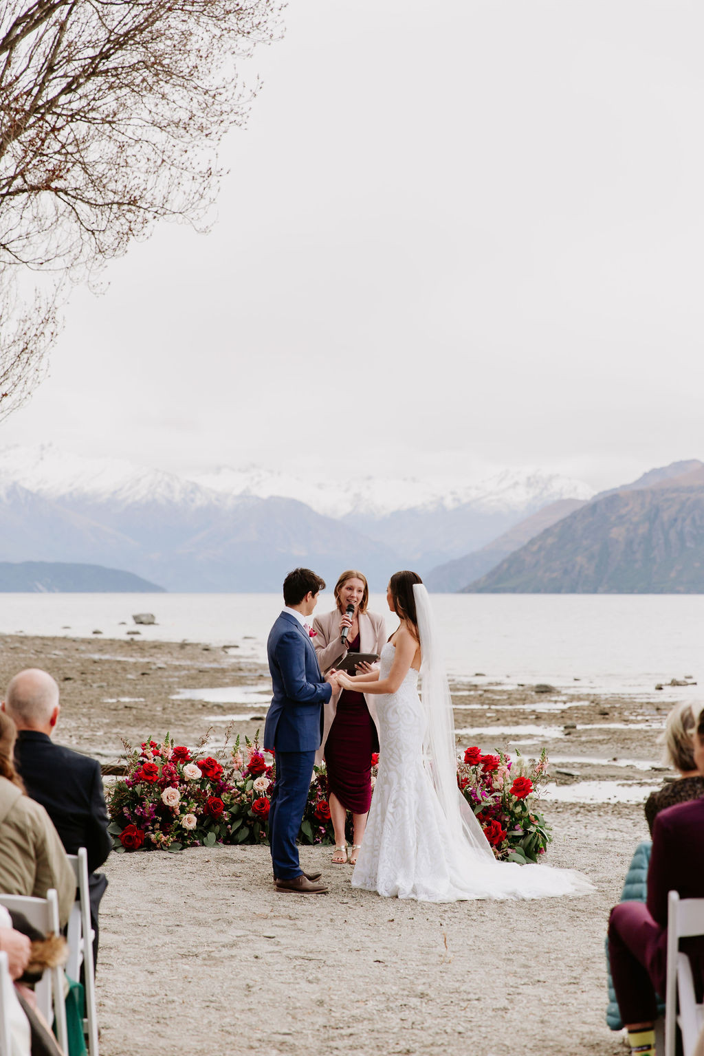 A couple getting married in front of Lake Wānaka