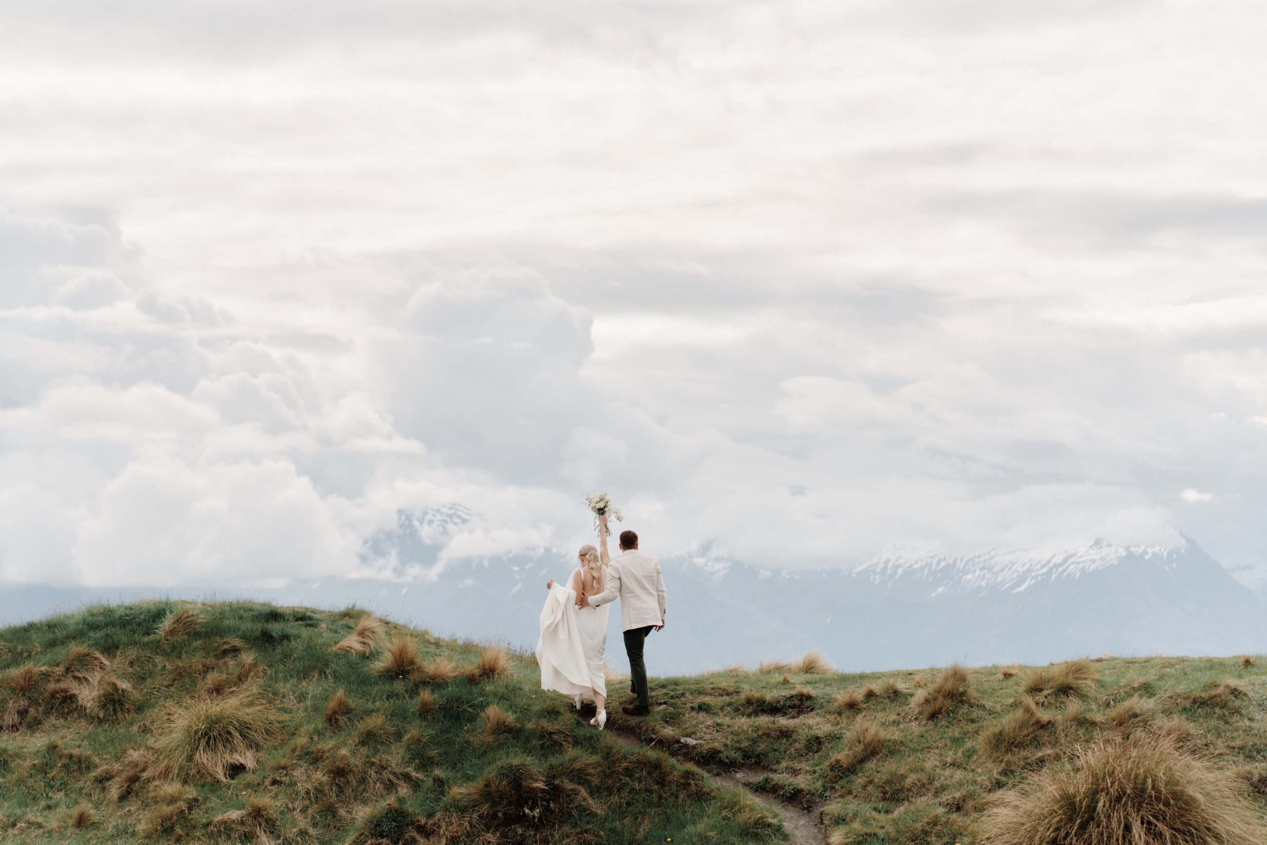 A&B enjoying their mountain wedding photoshoot at Coromandel Peak in Wanaka