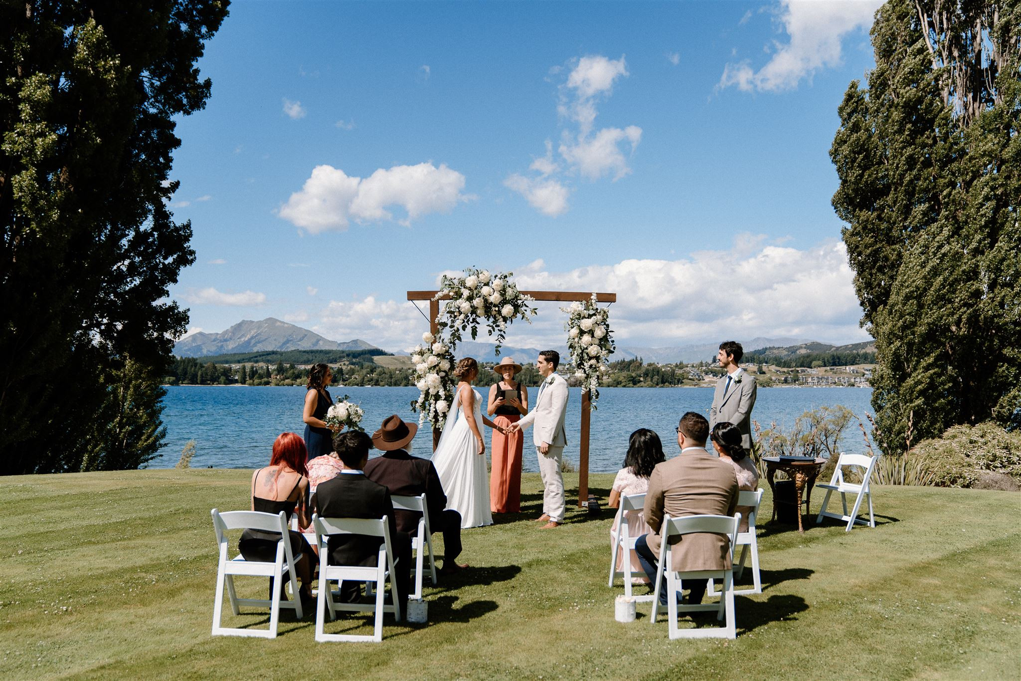 D&S's wanaka wedding ceremony on Edgewater's lawns. Lake Wānaka in the distance