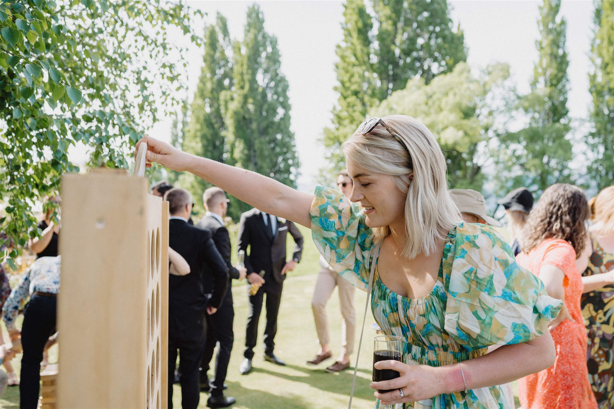 Wedding guest playing Connect Four at Edgewater - a Central Otago wedding venue
