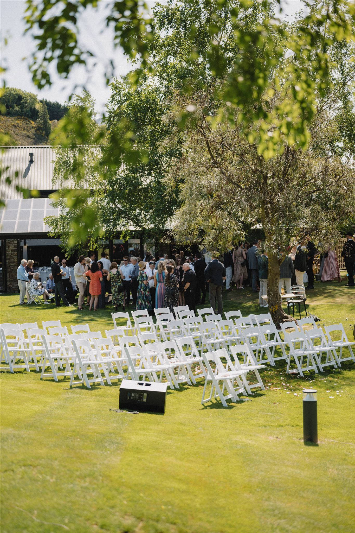 Edgewater's new zealand wedding packages include  up to 40 white chairs, set up on these rolling green lawns outside of the pavilion
